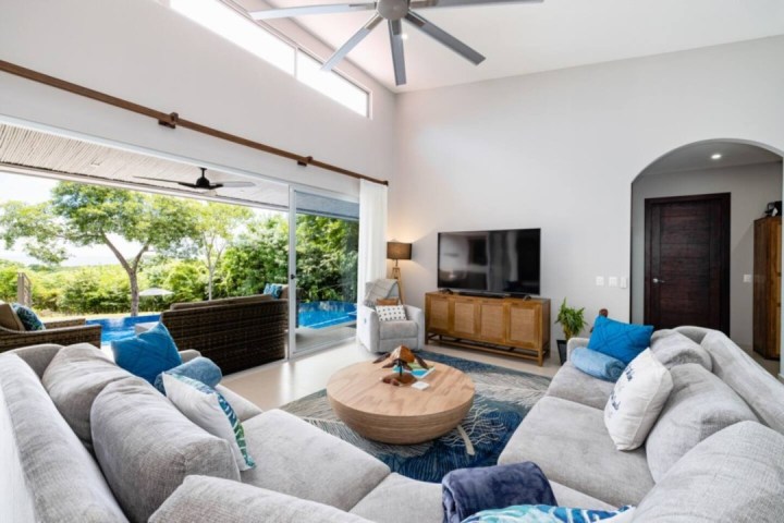 a living room filled with furniture and a large window