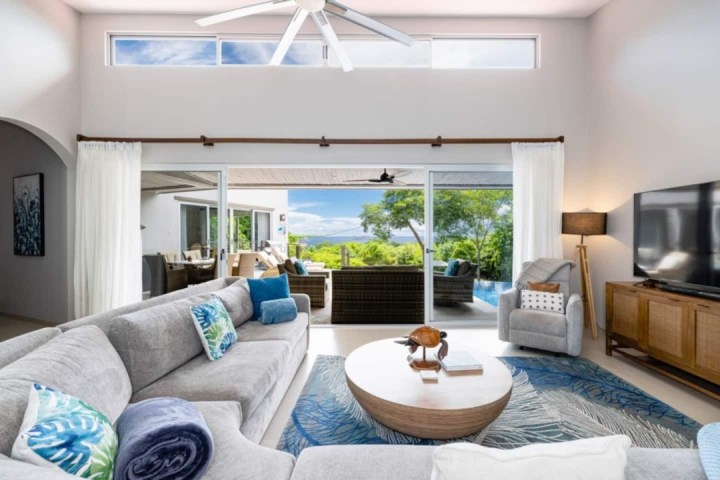 a living room filled with furniture and a large window