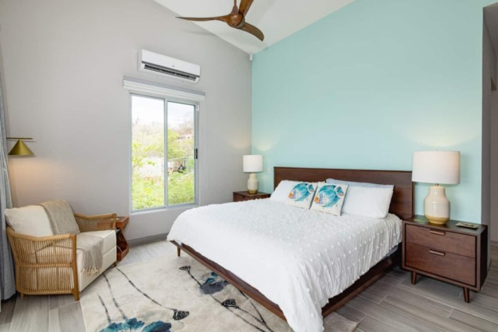 a bedroom with a bed and desk in a hotel room