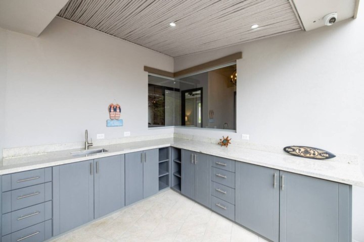 a kitchen with a sink and a mirror