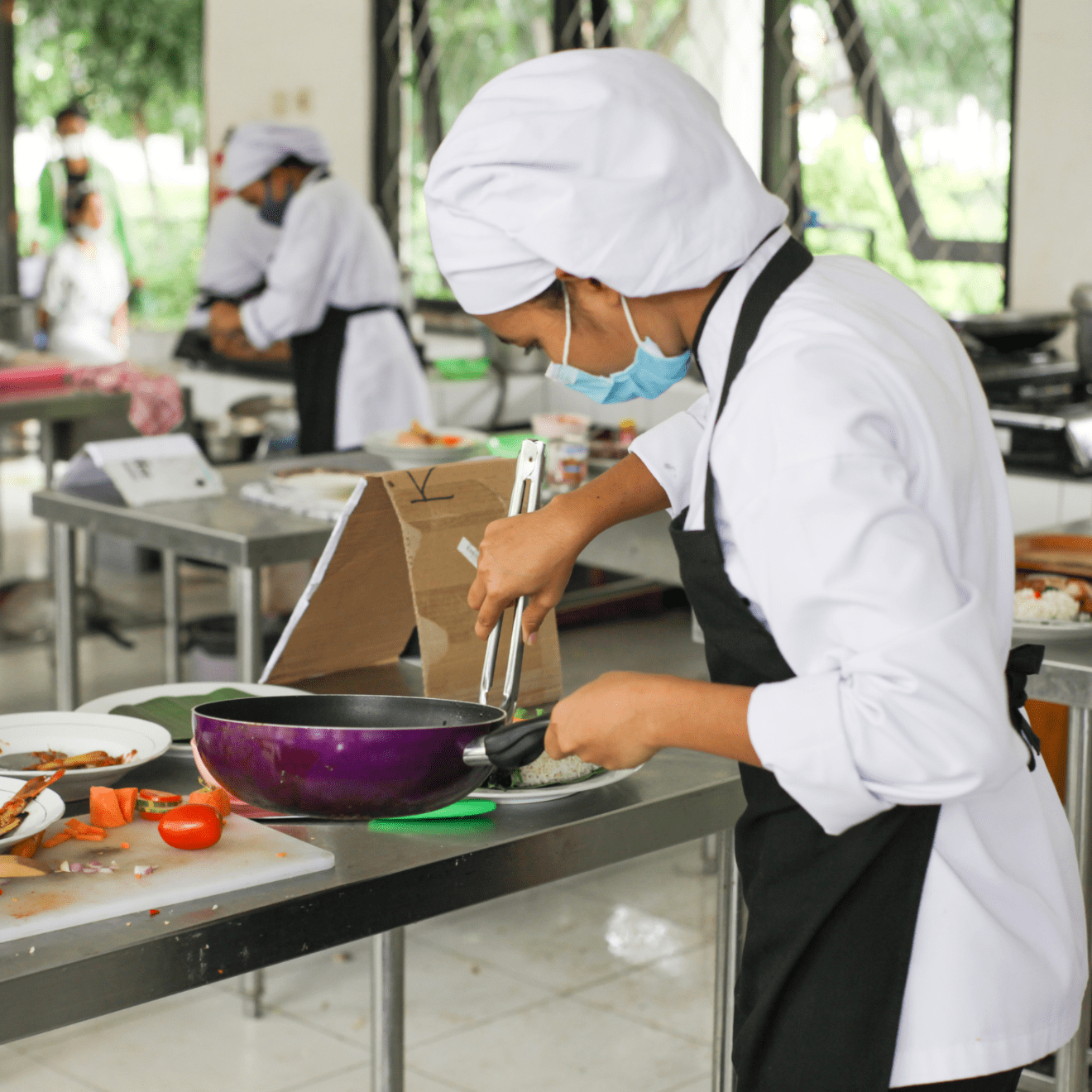 a person cooking in a kitchen preparing food