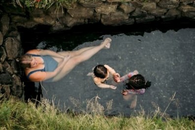 a young man lying on a rock