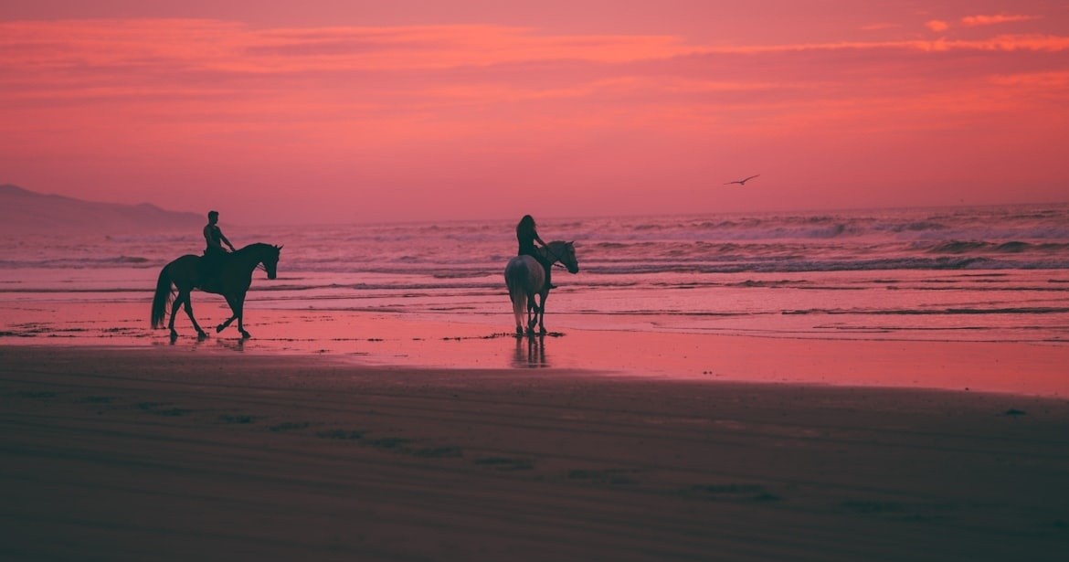 Horseback riding on a Guanacaste beach at sunset — regenerative travel experience in Costa Rica