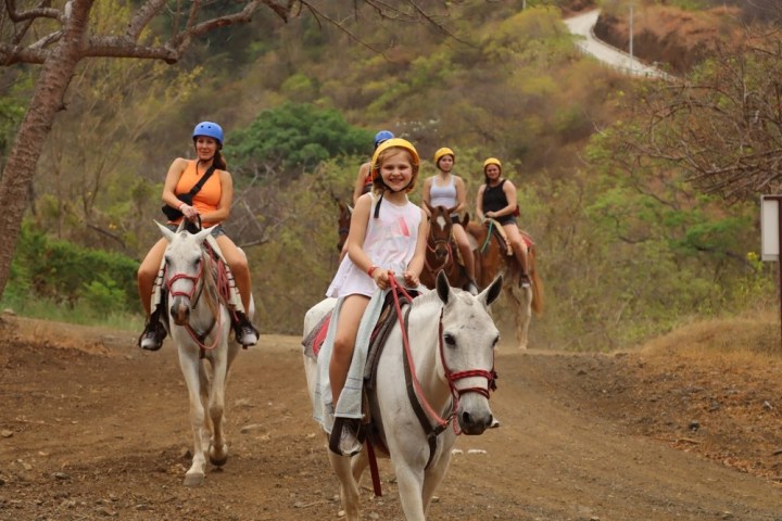 a man riding a horse on a dirt road