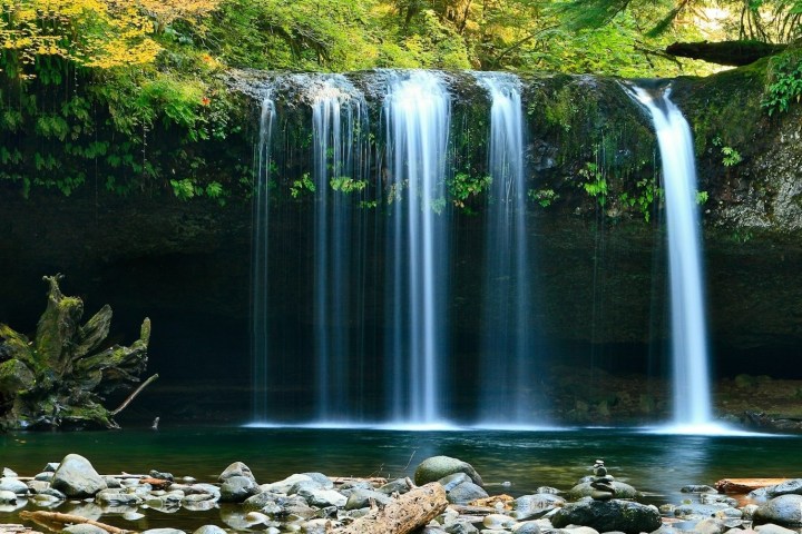 a large waterfall over some water