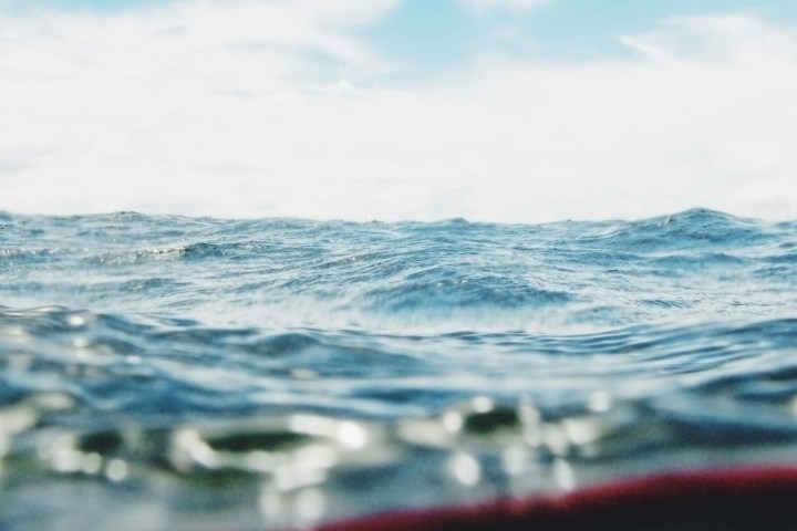 a man riding a wave on a surfboard in the water