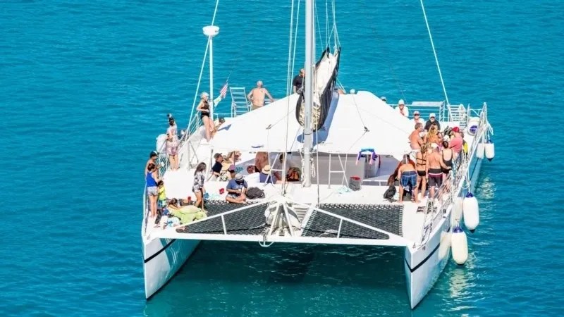 a group of people on a boat in a large body of water