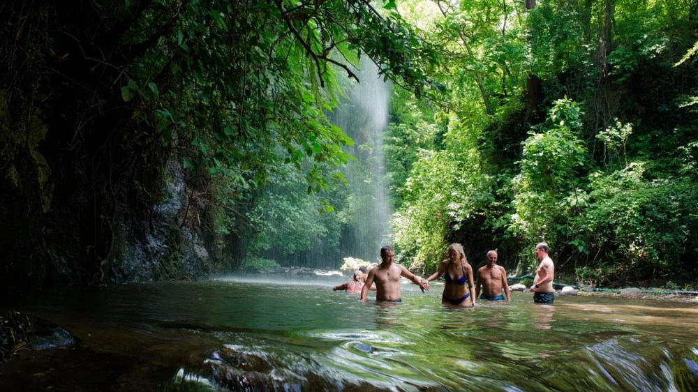 a group of people standing in a river