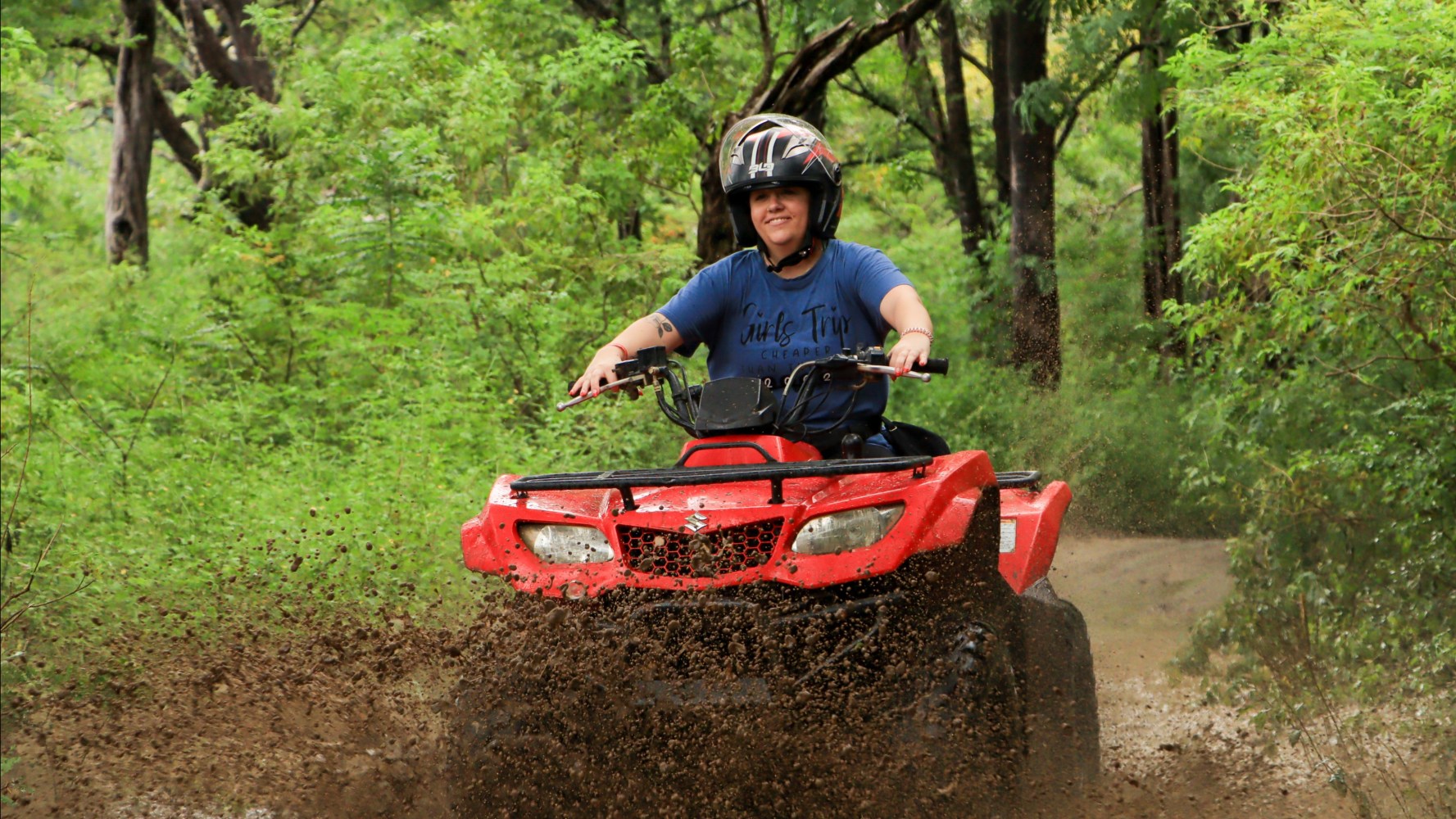 a man riding a bike down a dirt road