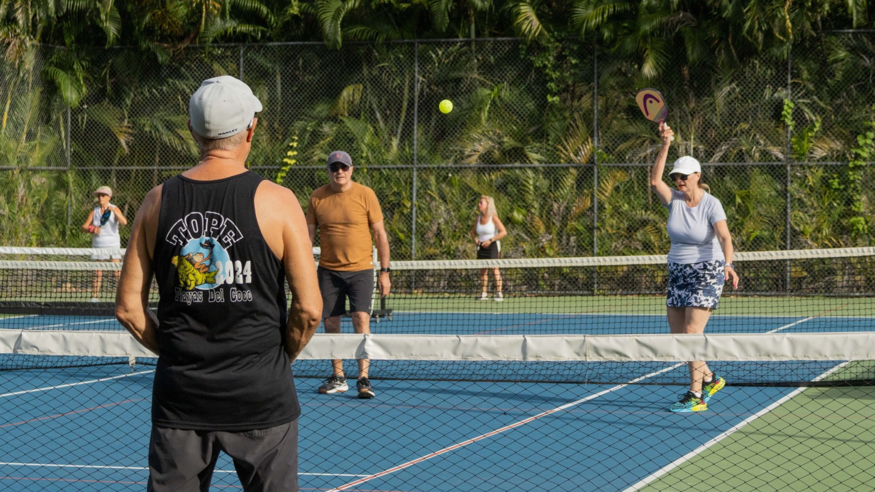 a group of people playing a game of frisbee on a court