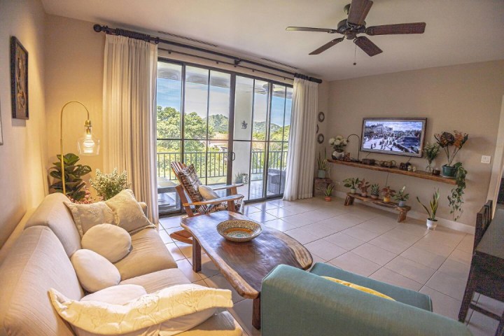 a living room filled with furniture and a large window