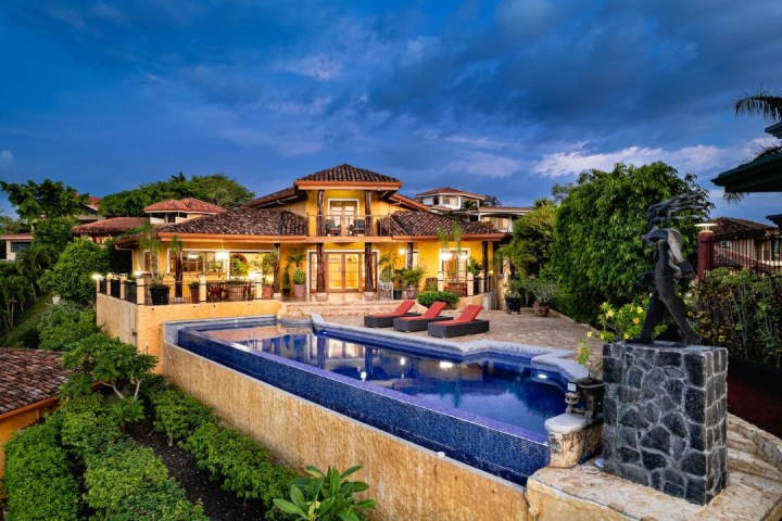 a house with a pool outside of a building