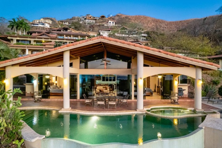 a large building with a mountain in the background