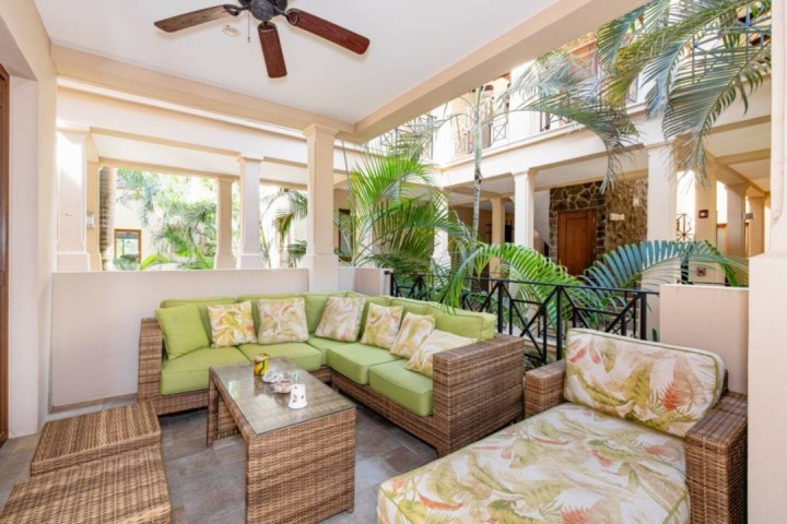 a living room filled with furniture and a large window