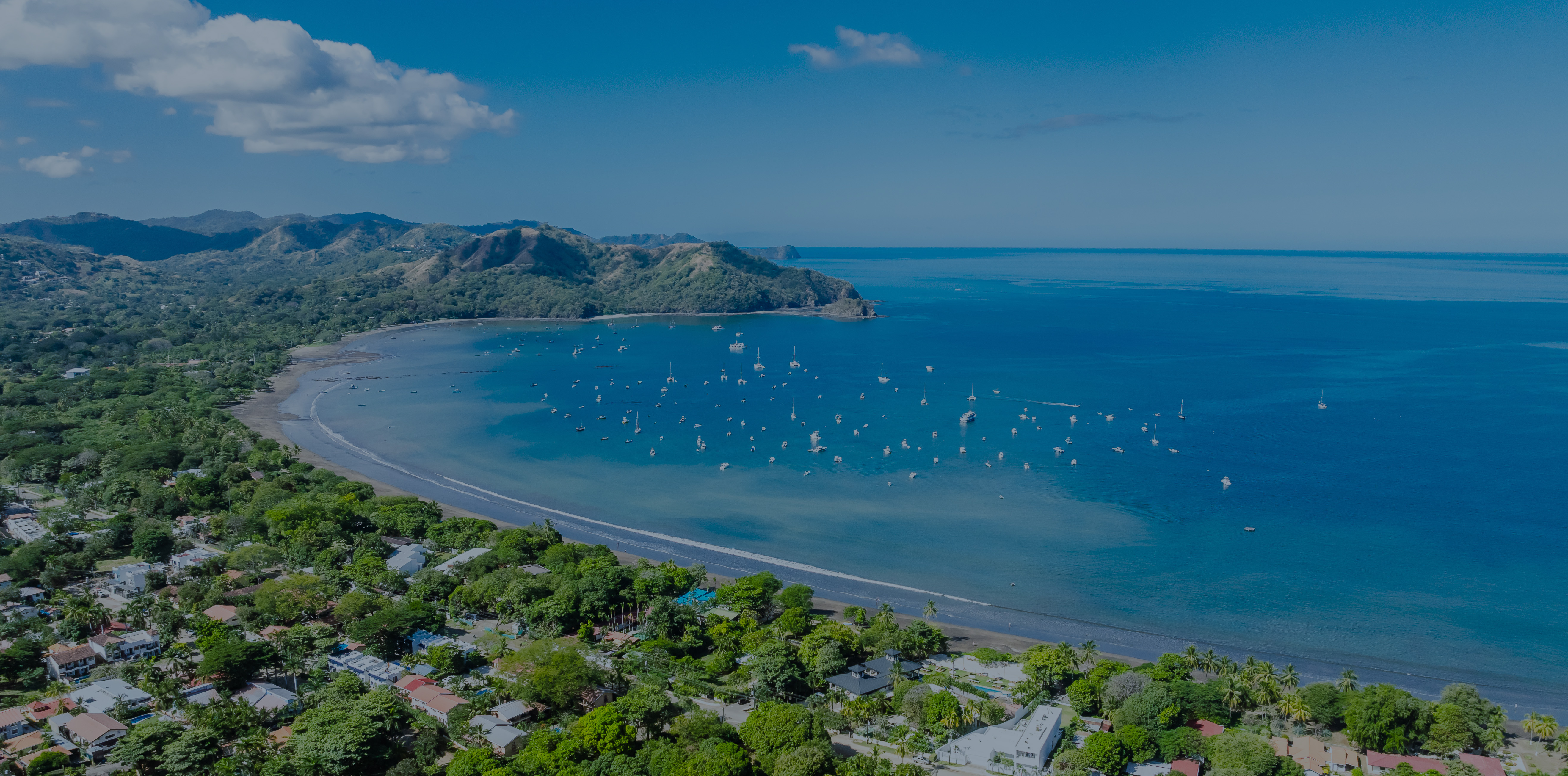 Aerial view of Guanacaste coastline with turquoise waters and tropical hills — Zindis Vacation Rentals