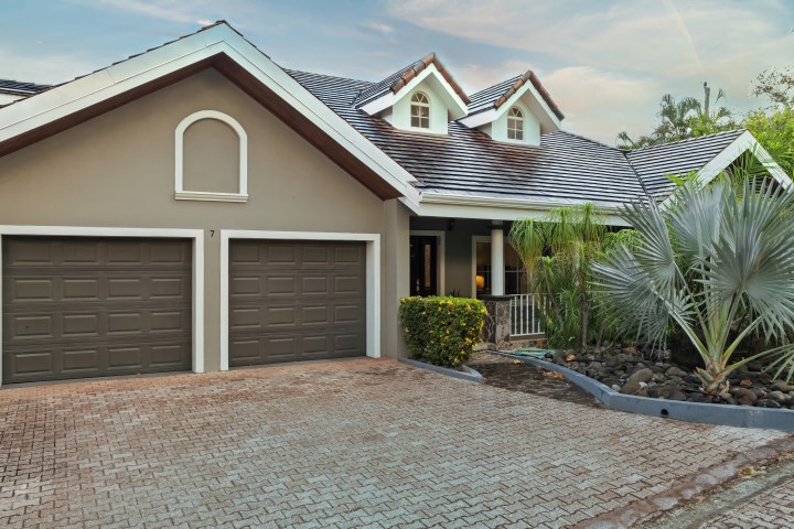 Modern house with two garages and a landscaped driveway